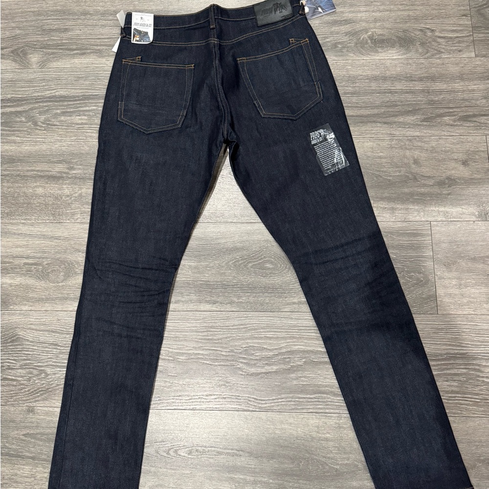 Blue Skinny Jeans with Deep Indigo Color and Visible Stitching